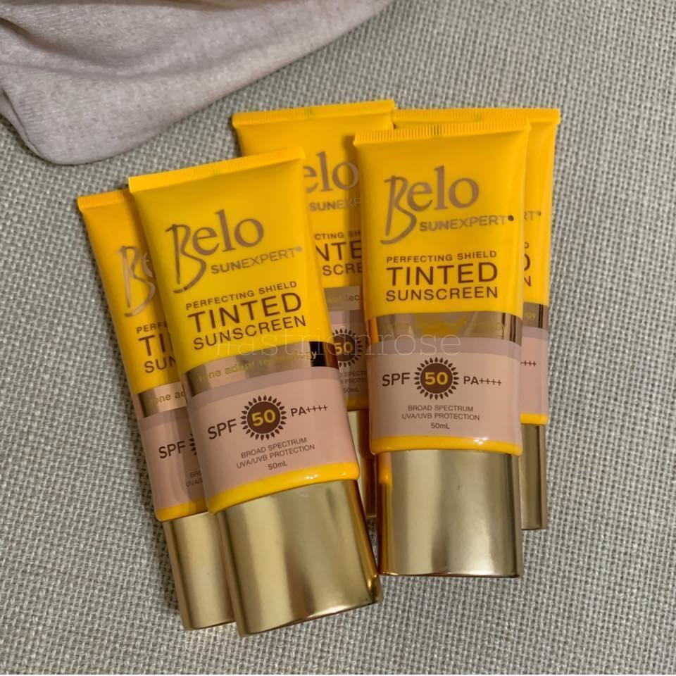 Belo SunExpert tinted sunscreen SPF 50 tubes arranged on a textured surface
