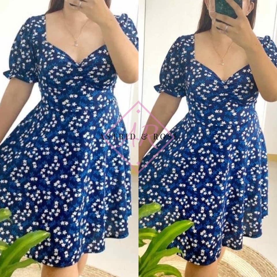 Plus size woman wearing blue floral puff sleeve dress with sweetheart neckline