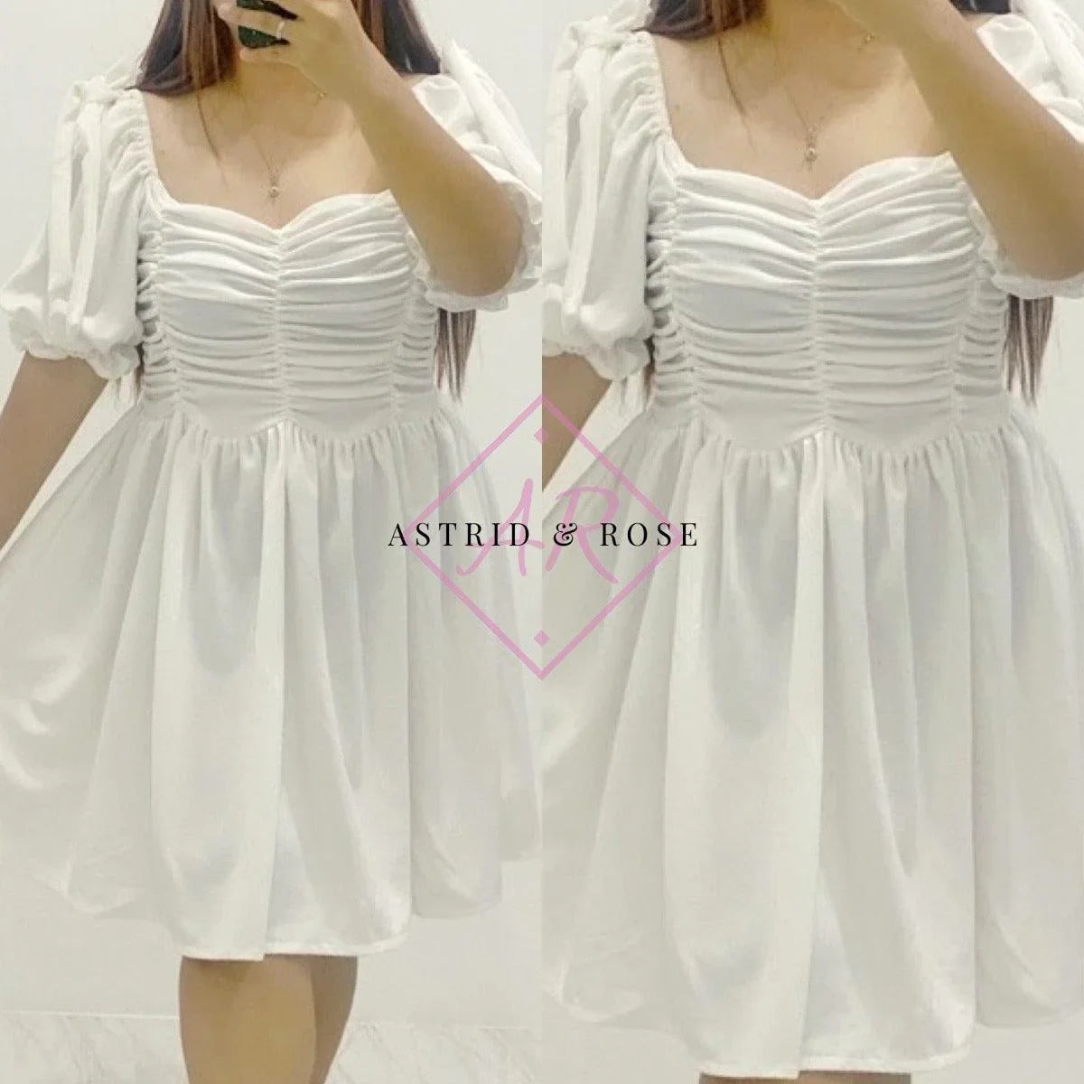 Plus size white dress with ruched bodice and puff sleeves modeled indoors