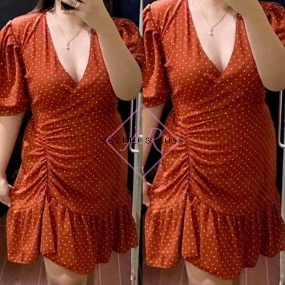 Plus size rust polka dot wrap dress with puff sleeves and ruched side detail