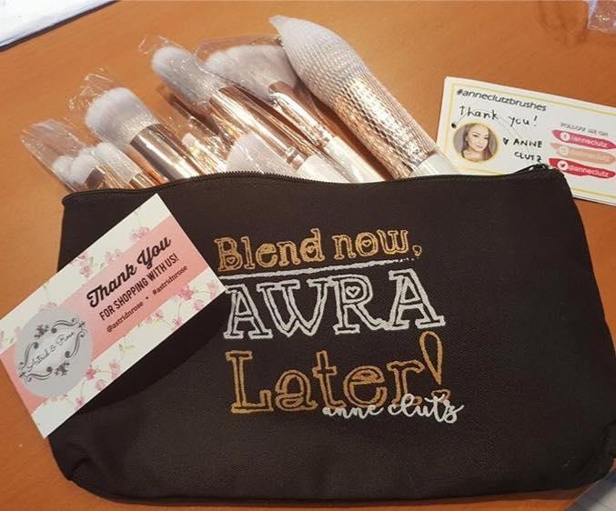 Beginner makeup brush set with rose gold handles in a pouch that says 'Blend now, AWRA Later!'