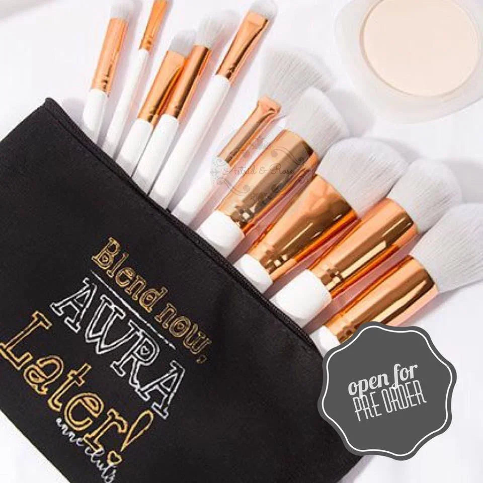 Beginner makeup brush set with white and gold handles in black pouch, powder compact nearby
